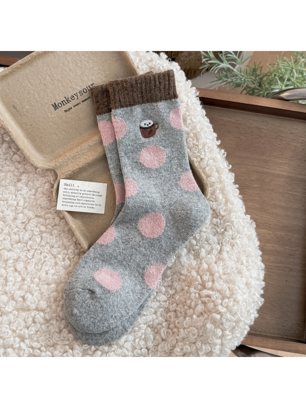 Cup socks with pink polka dots, a cup motif, and brown ribbed cuffs.