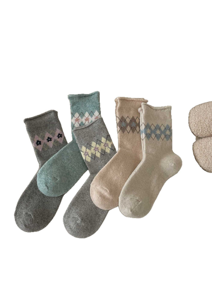 Five argyle socks in Ivory, Beige, Blue, Heather Gray, and Dark Gray on a white background.