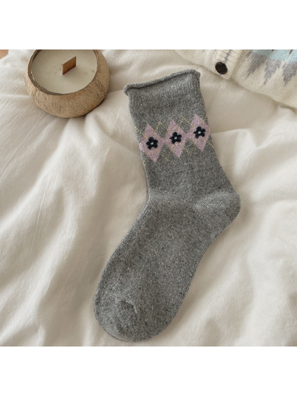 Dark Gray sock with pink argyle diamonds, black floral centers, and a rolled cuff.