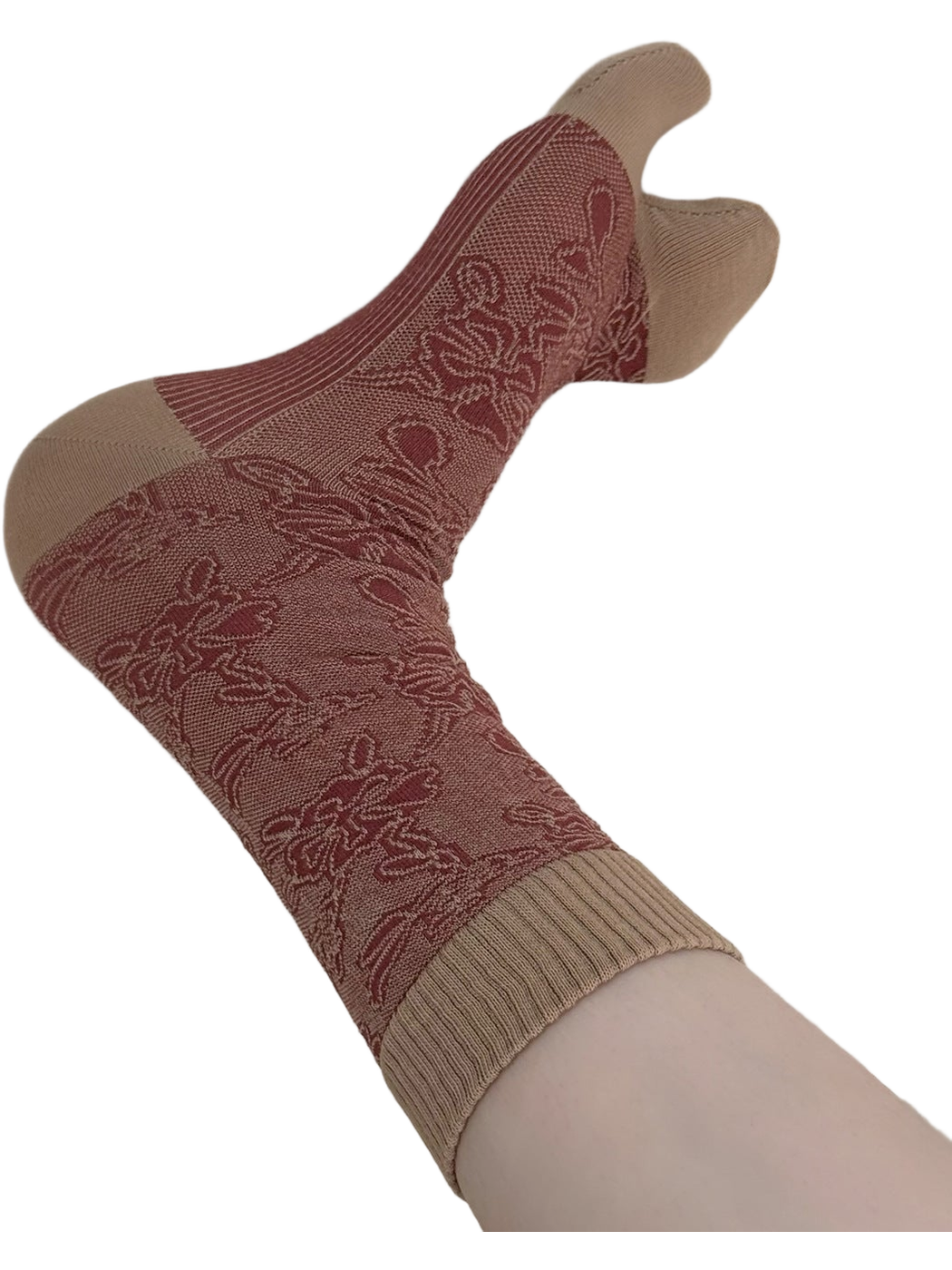 Close view of a beige-and-red floral split-toe sock with a ribbed cuff.