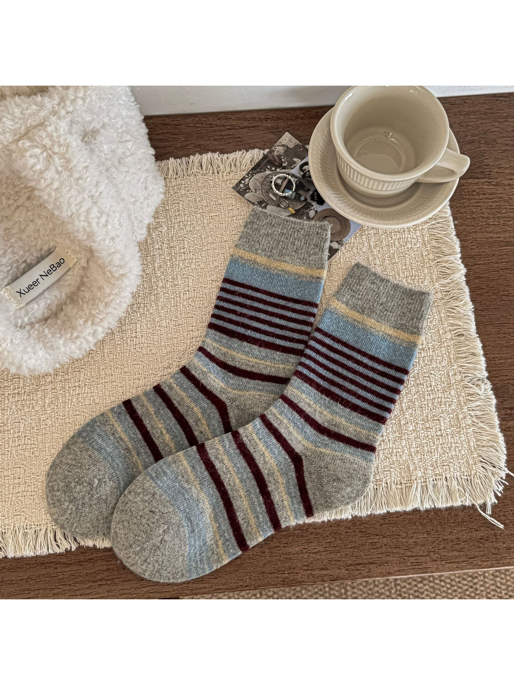 Light gray crew socks with pale blue and burgundy stripes and ribbed cuffs.