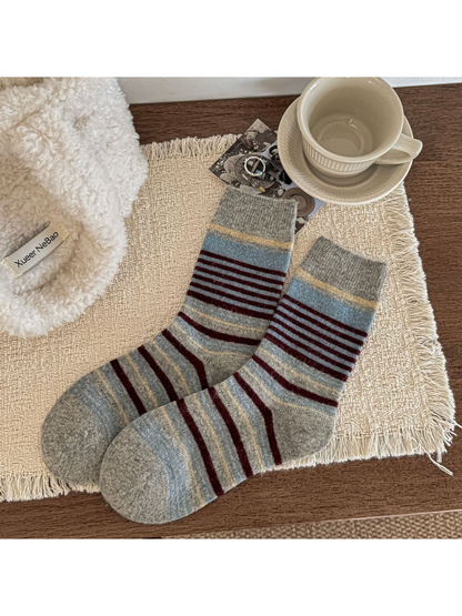 Light gray crew socks with pale blue and burgundy stripes and ribbed cuffs.
