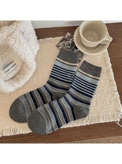 Dark gray crew socks with pale blue and navy stripes and ribbed cuffs.