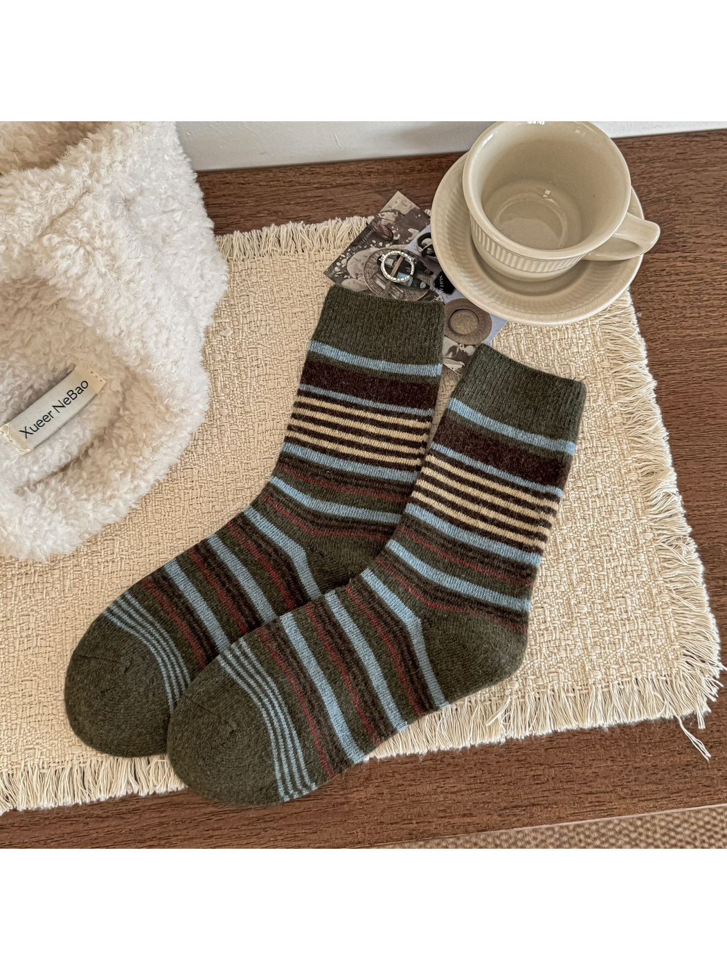 Green crew socks with pale blue, brown and cream stripes and ribbed cuffs.