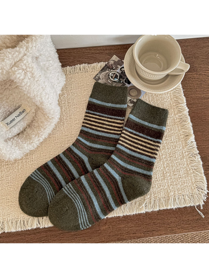 Green crew socks with pale blue, brown and cream stripes and ribbed cuffs.
