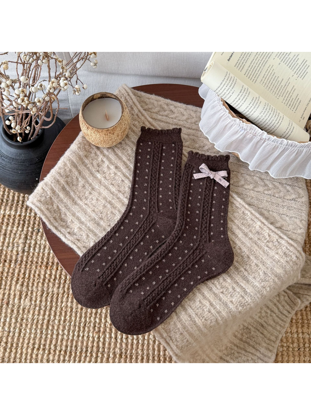 Brown socks with small light dots, cable-textured bands, scalloped cuffs, and a pale pink bow.