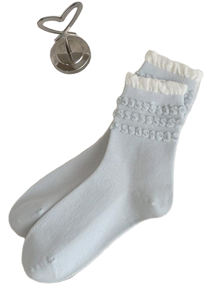Light blue Loops socks with three raised loop rows and white ruffled cuffs.