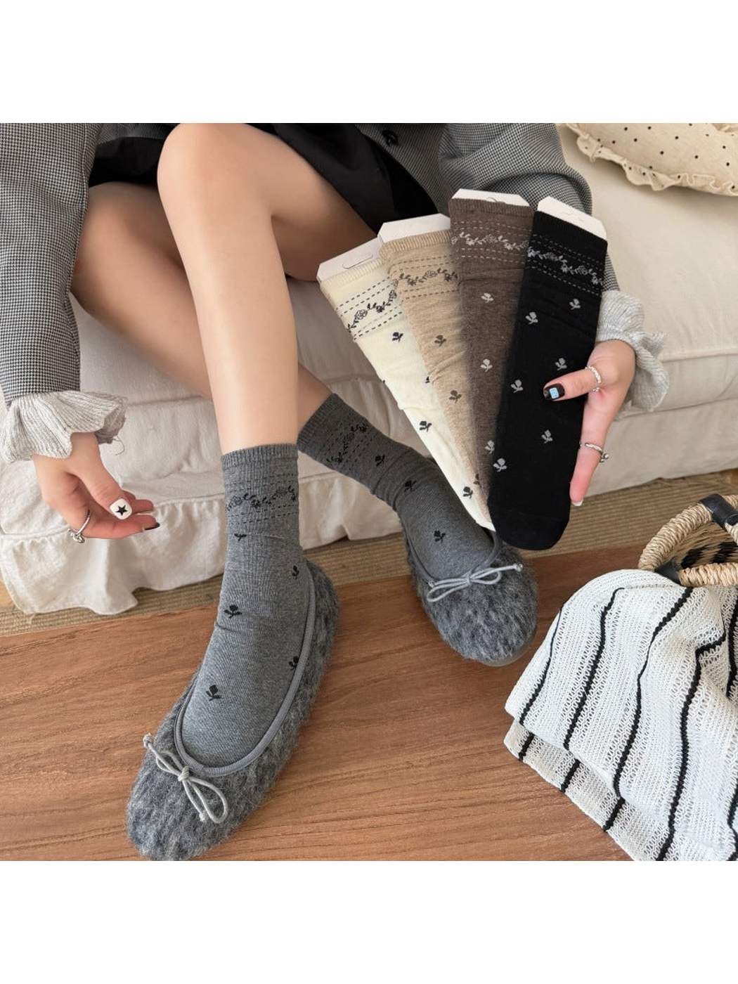 Gray floral socks worn with bow shoes beside Ivory, Beige, Brown and Black socks.