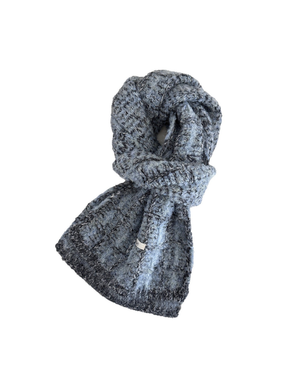 Blue plaid scarf looped on a white background, showing its fuzzy knit texture and dark end borders.