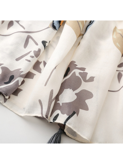 Close-up of the gray floral print continuing to the narrow stitched hem
