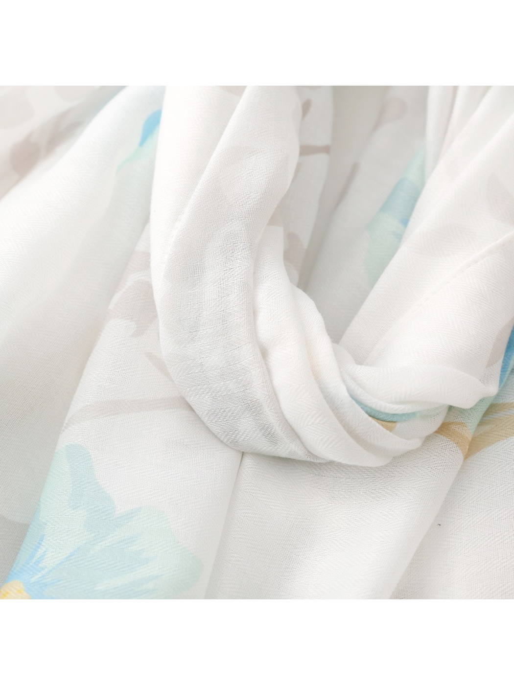 Close-up of the white scarf ground and fine semi-transparent weave