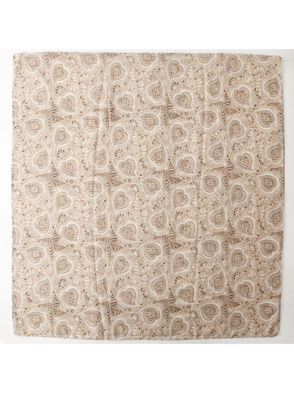 Khaki and brown paisley scarf laid flat to show its overall shape and repeating pattern