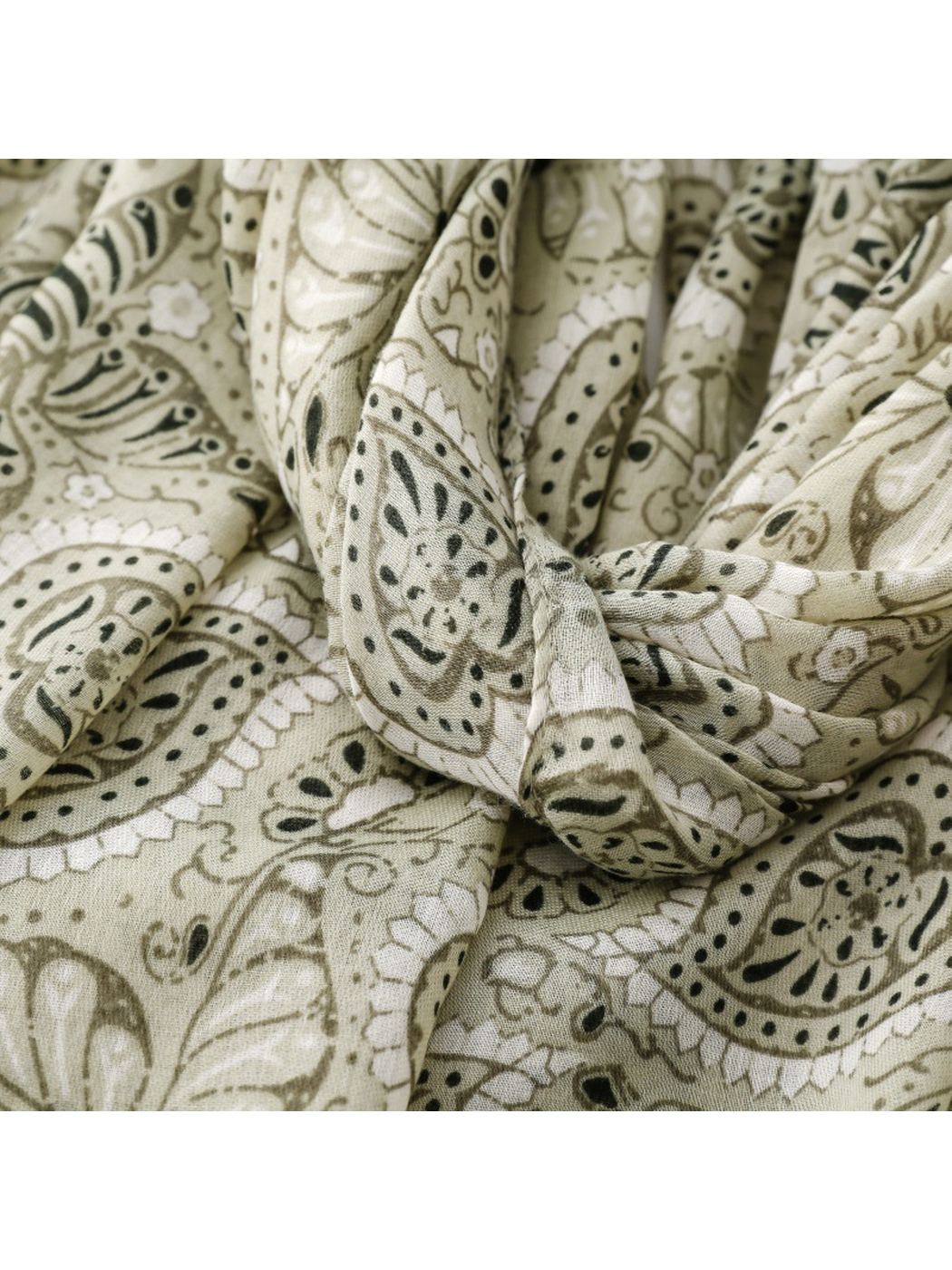 Close-up of the sage and dark green paisley scarf in gathered folds