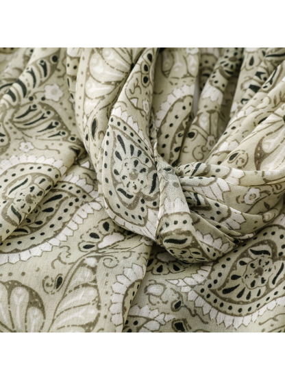 Close-up of the sage and dark green paisley scarf in gathered folds