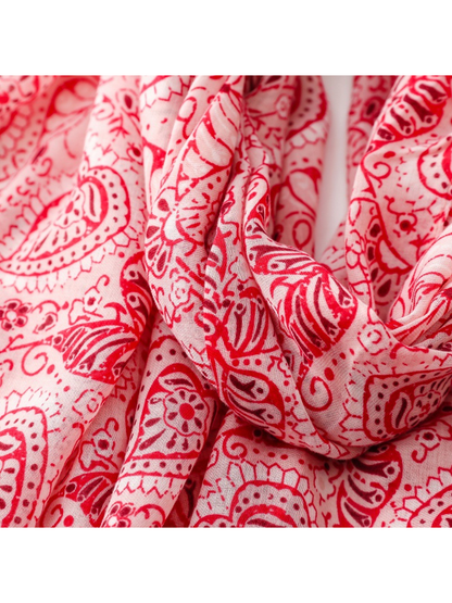 Close-up of the red paisley scarf print and fine woven texture in looped folds