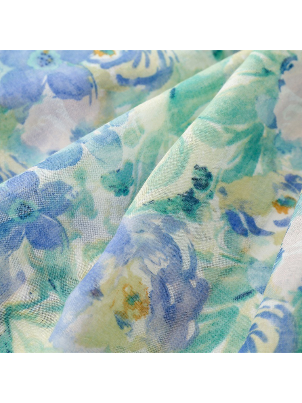 Close-up of the semi-sheer blue and mint watercolor floral pattern