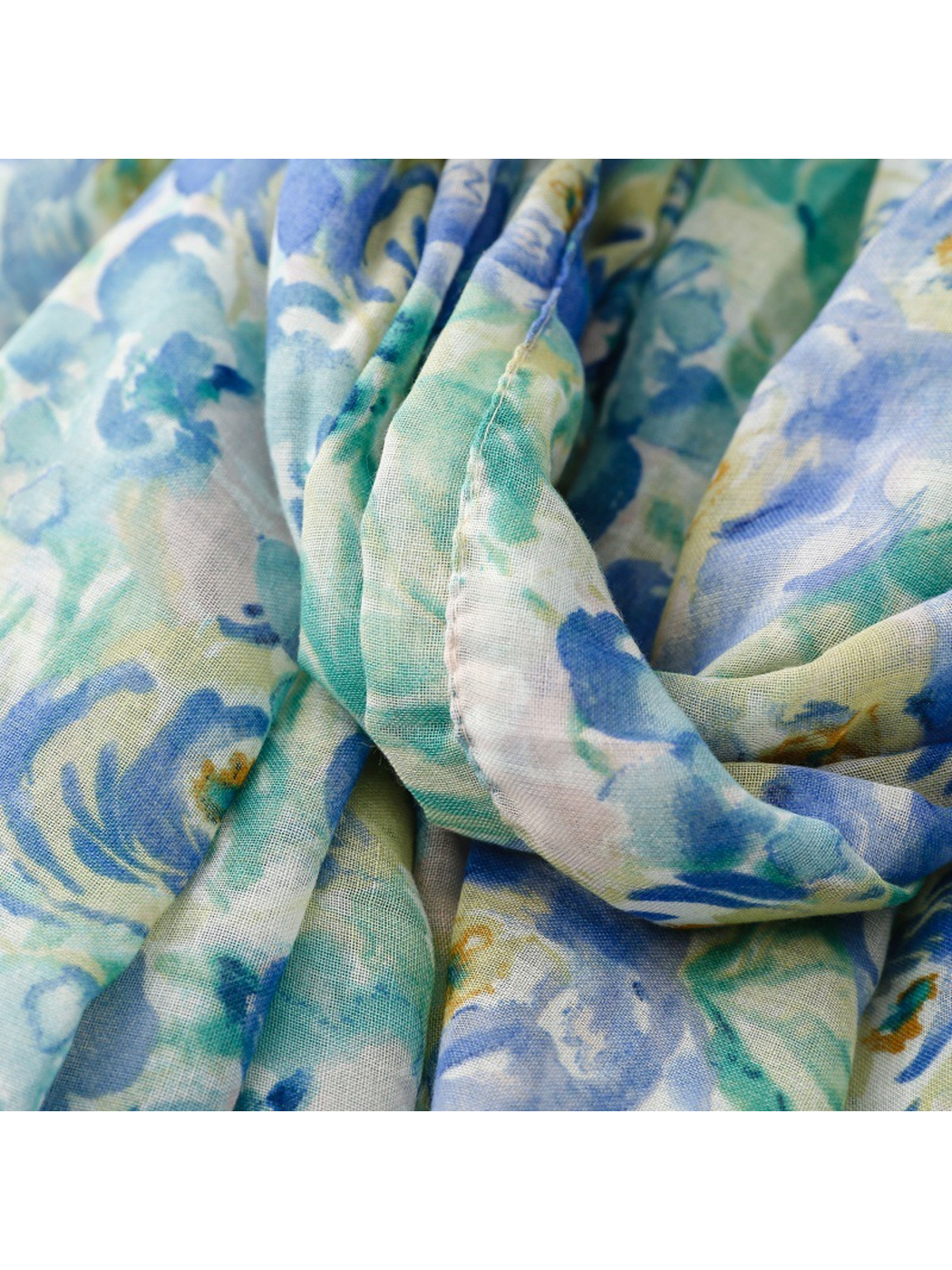 Close-up of the narrow stitched hem and fine weave on the floral scarf