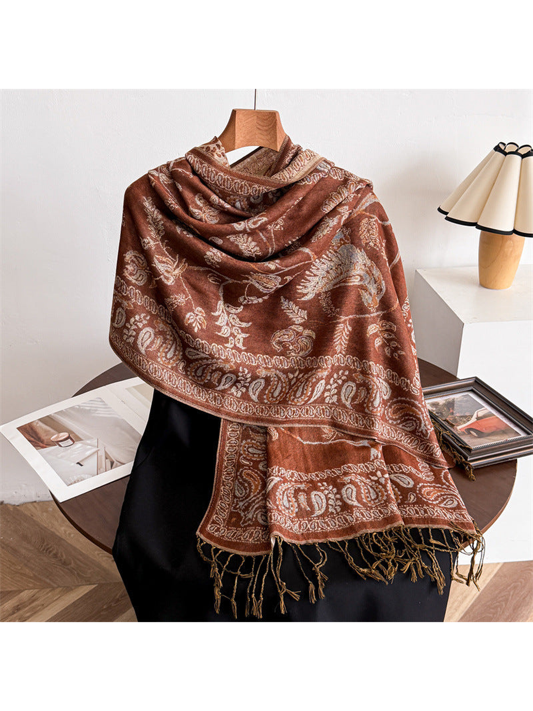 Caramel bird and paisley scarf draped over a black mannequin