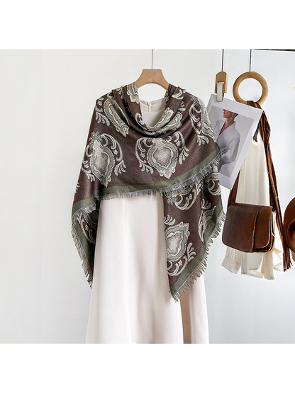 Brown paisley square scarf wrapped asymmetrically over a white dress