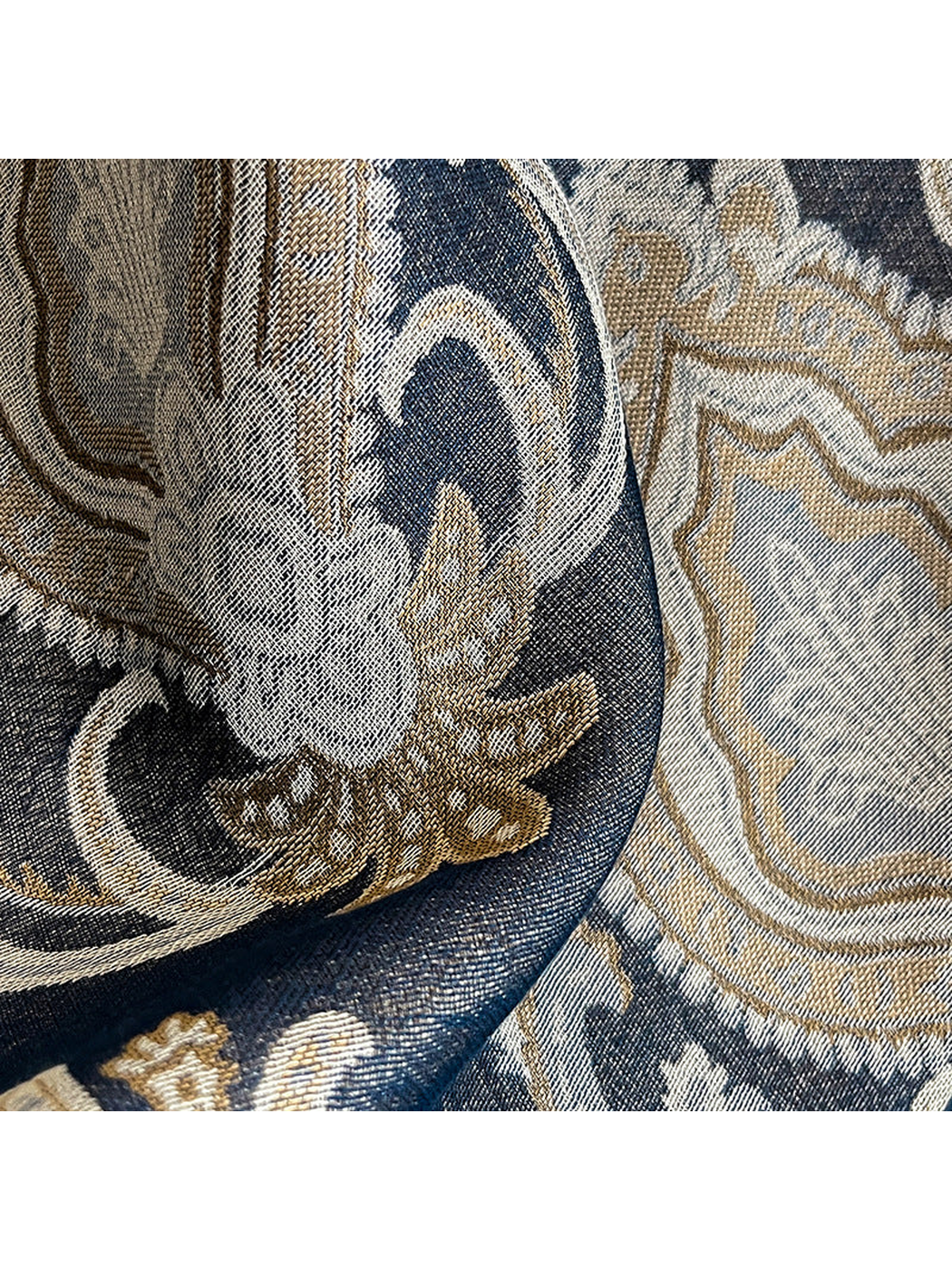 Close-up of the paisley weave in navy, cream, and tan tones