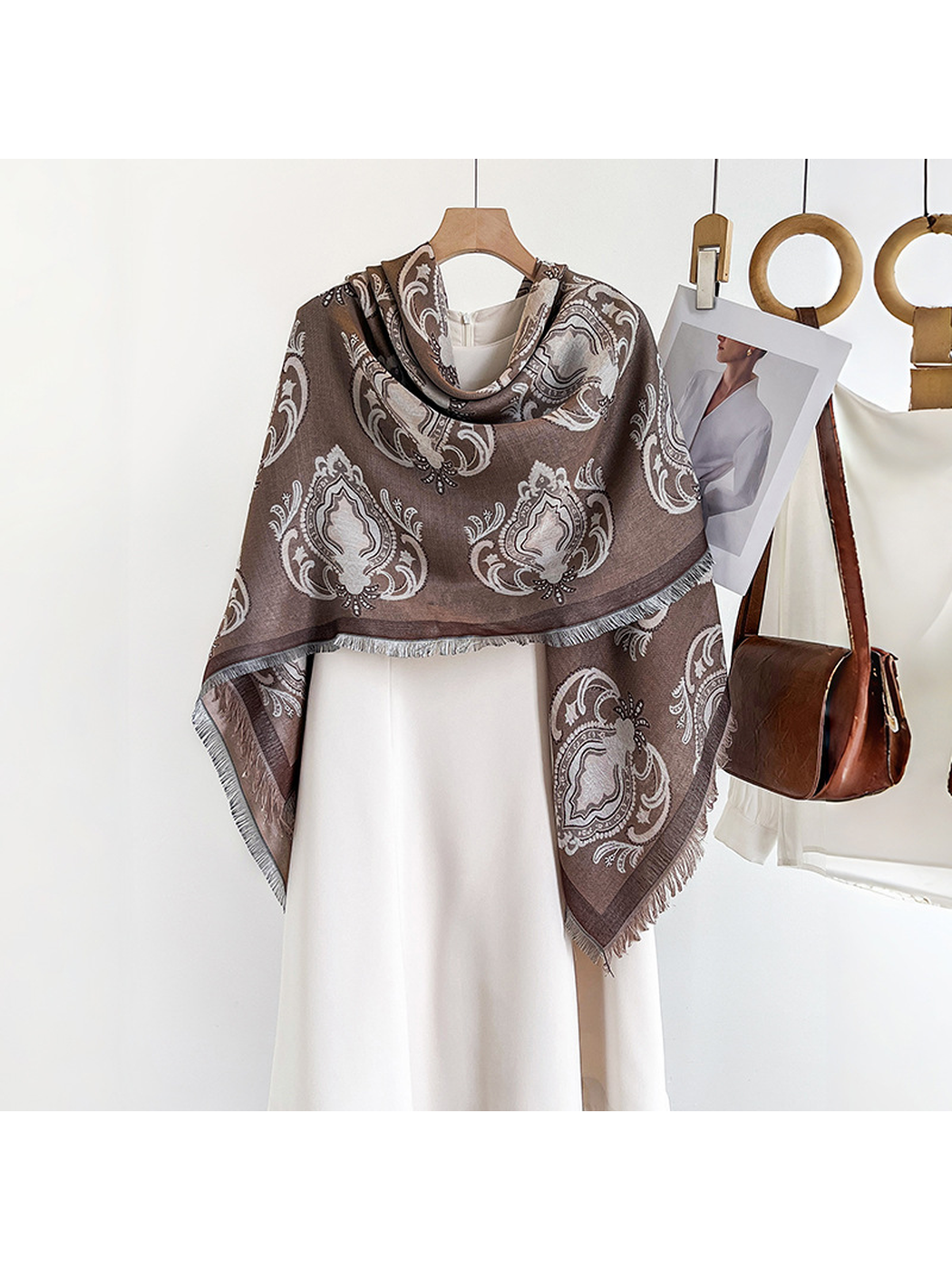 Light brown paisley scarf wrapped across a white dress