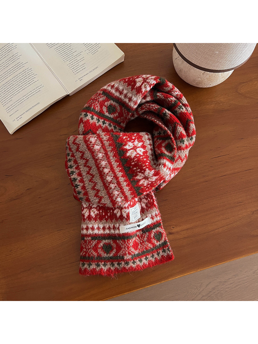 Red geometric-pattern scarf arranged on a wooden table