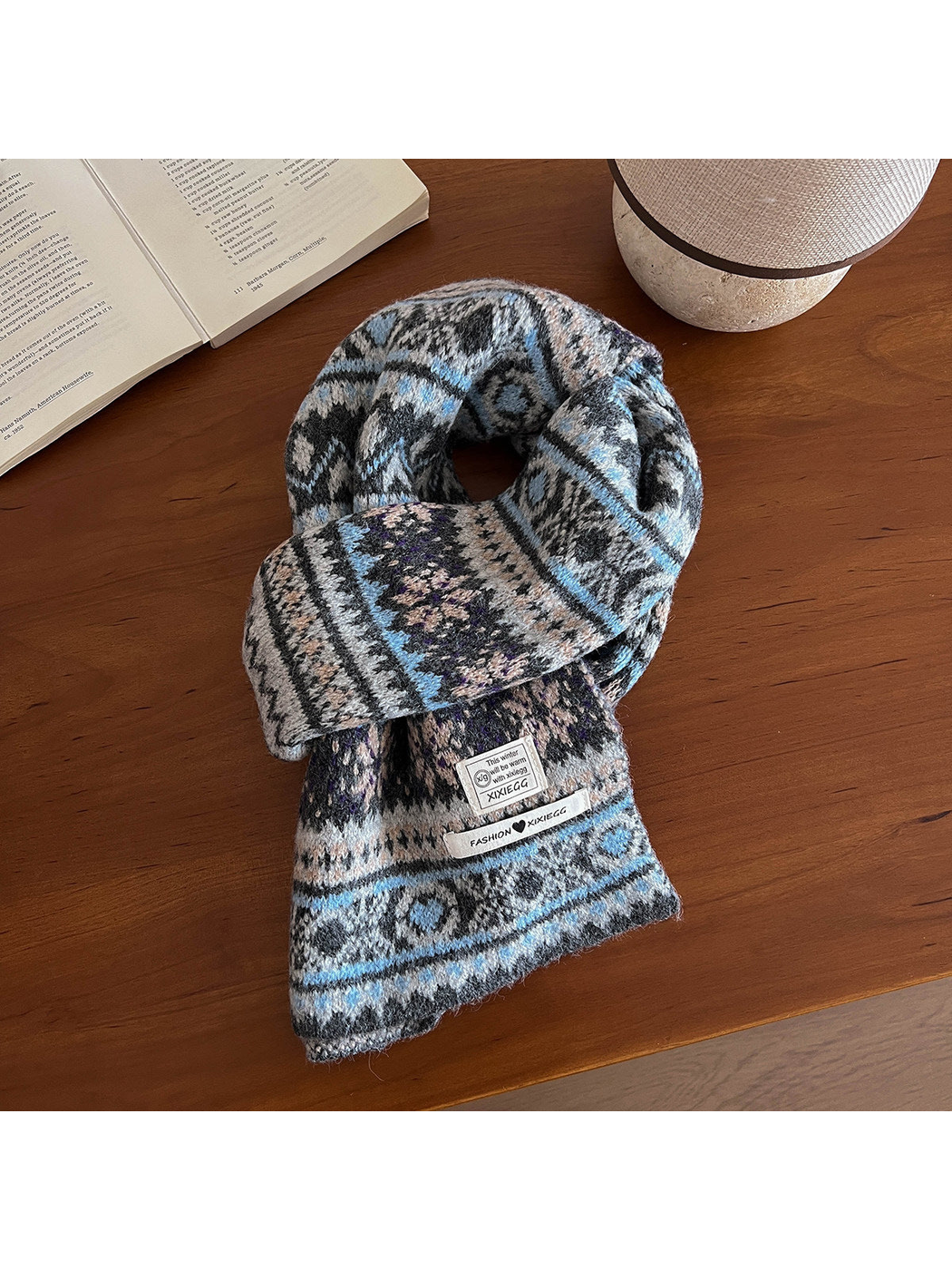 Blue-gray geometric-pattern scarf arranged on a wooden table