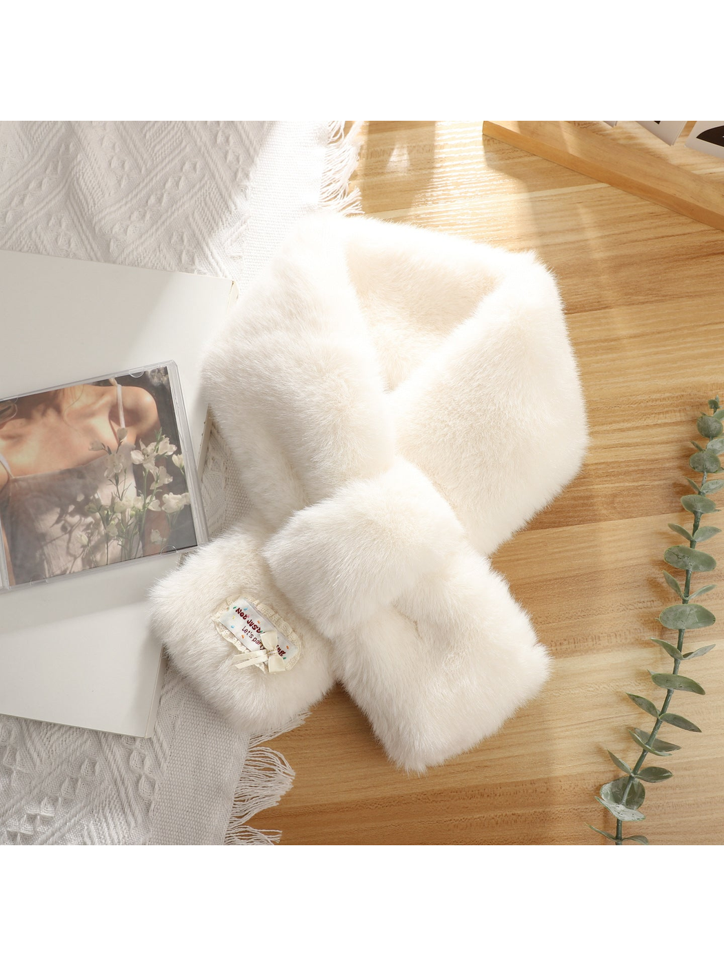 White fuzzy pull-through scarf with decorative bow patch