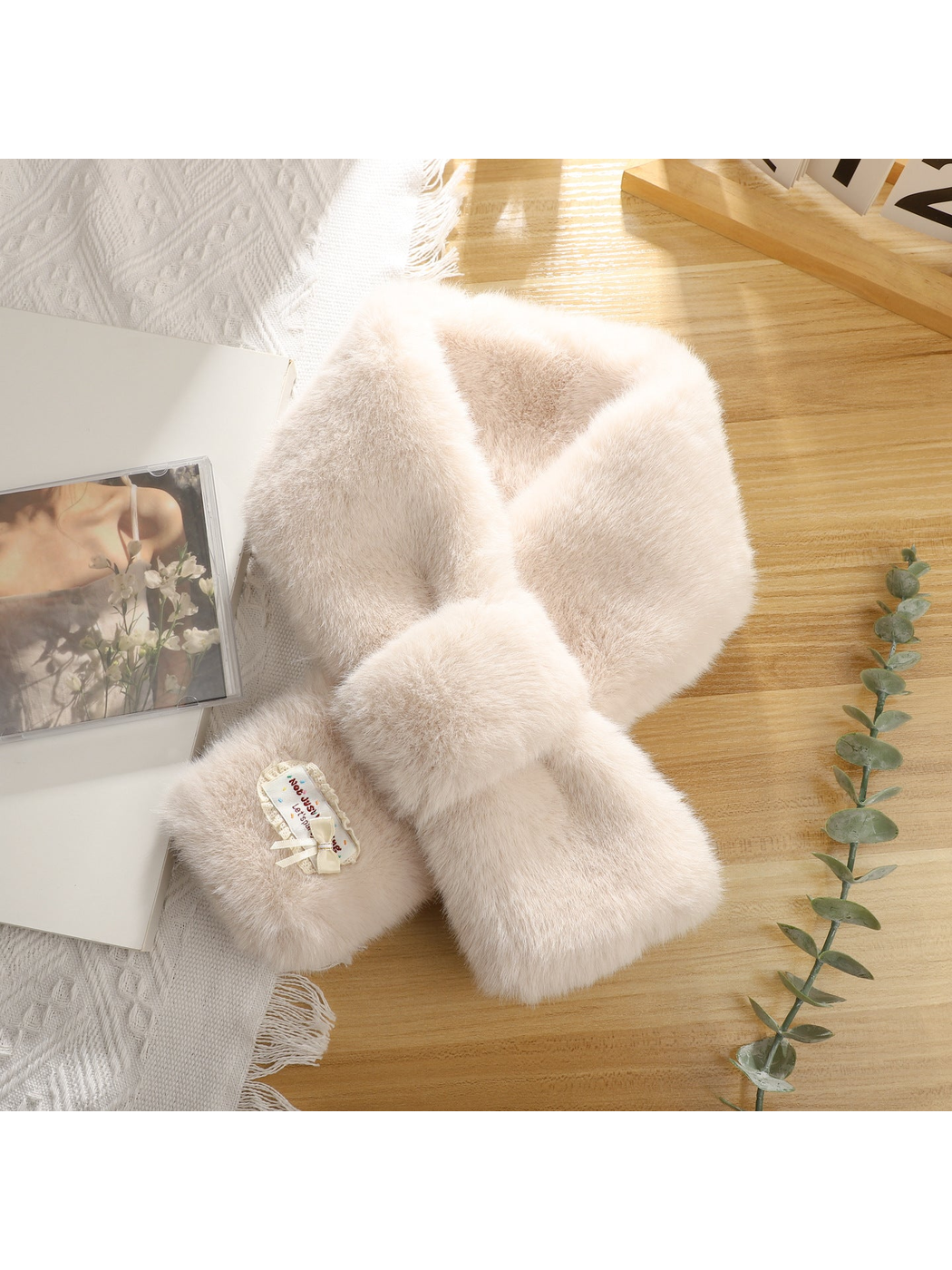 Off-white fuzzy pull-through scarf with decorative bow patch