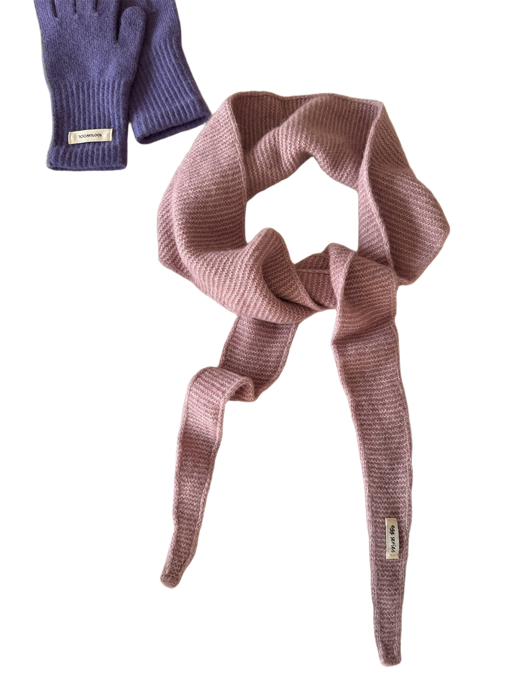Dusty pink textured narrow scarf with tapered ends arranged in a loose knot