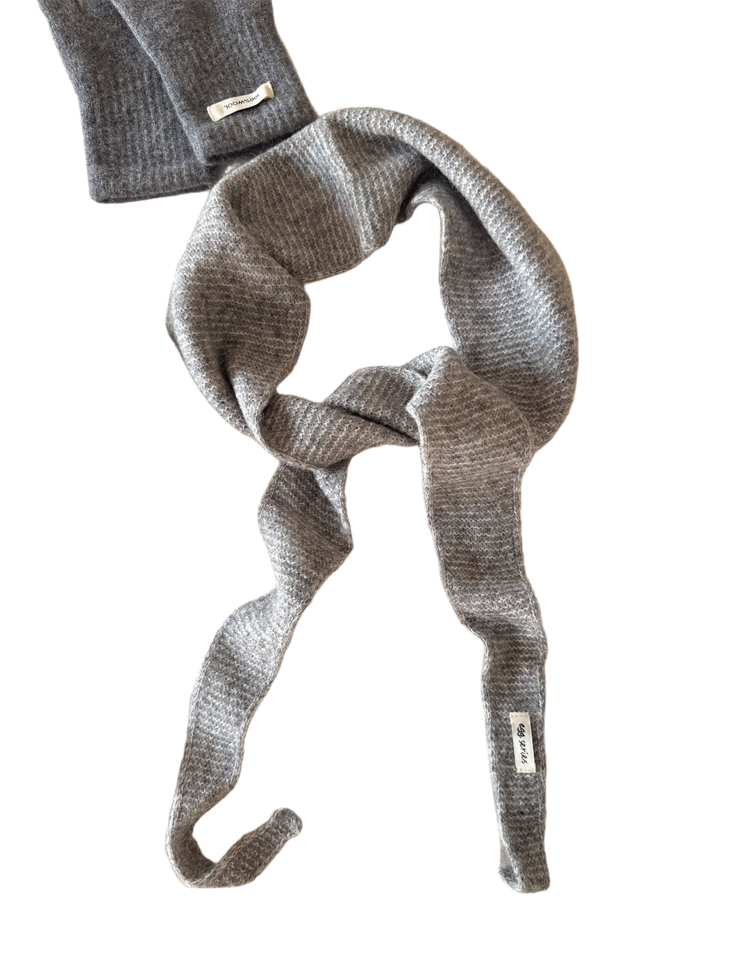 Gray textured narrow scarf with tapered ends arranged in a loose knot