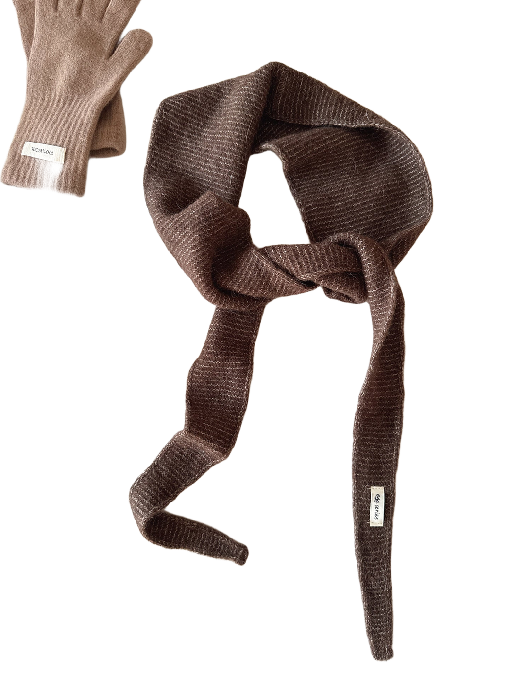 Dark brown textured narrow scarf with tapered ends arranged in a loose knot