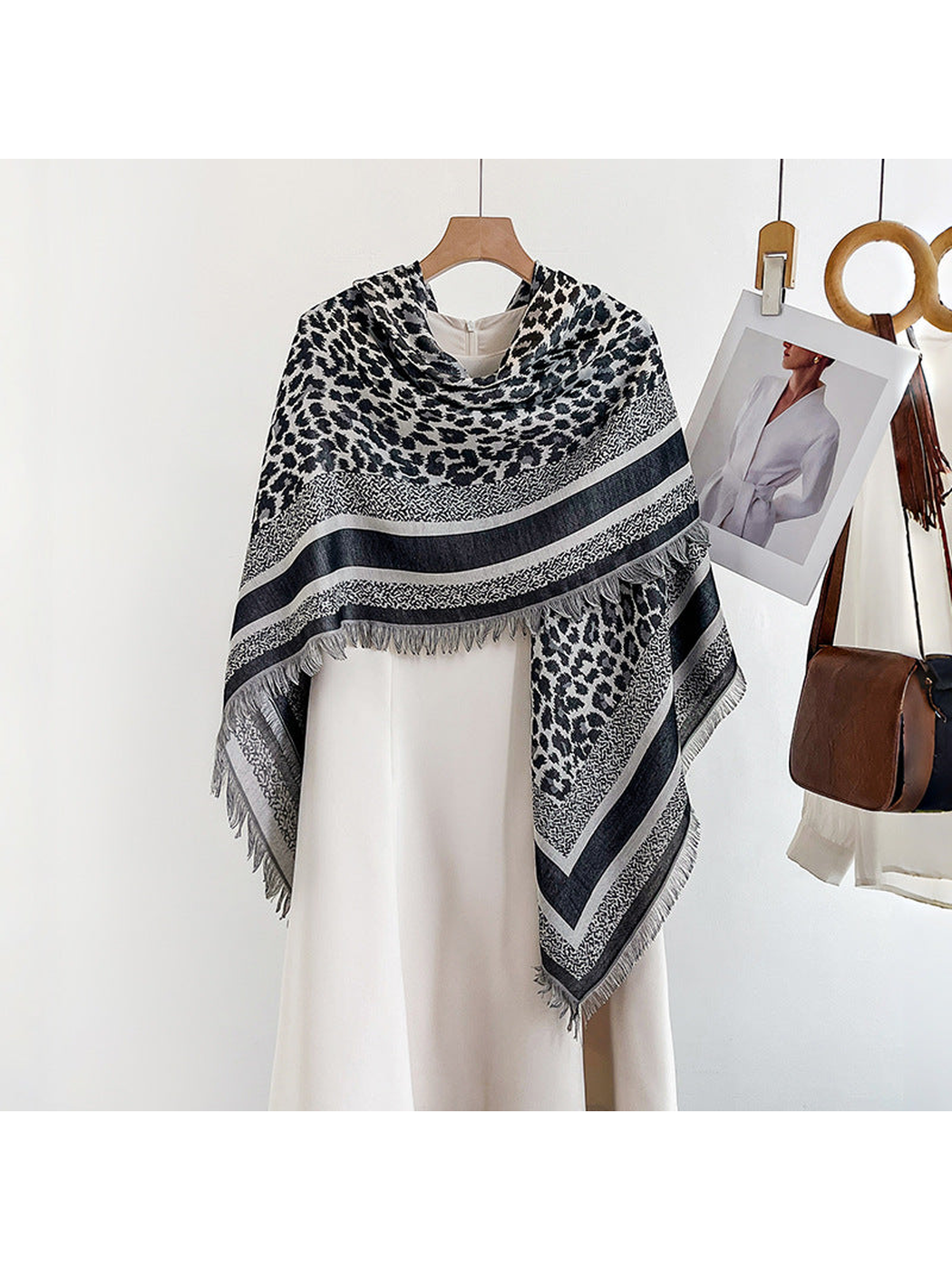 Black and ivory animal-print square scarf draped over a white dress