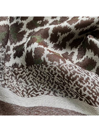 Close-up of the woven animal print and patterned scarf border