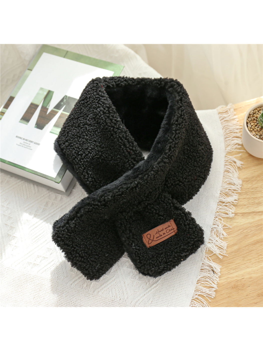 Black short neck scarf with crossed ends and curly textured surface