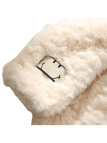 Close-up of the fuzzy cream scarf and outlined smiling face patch