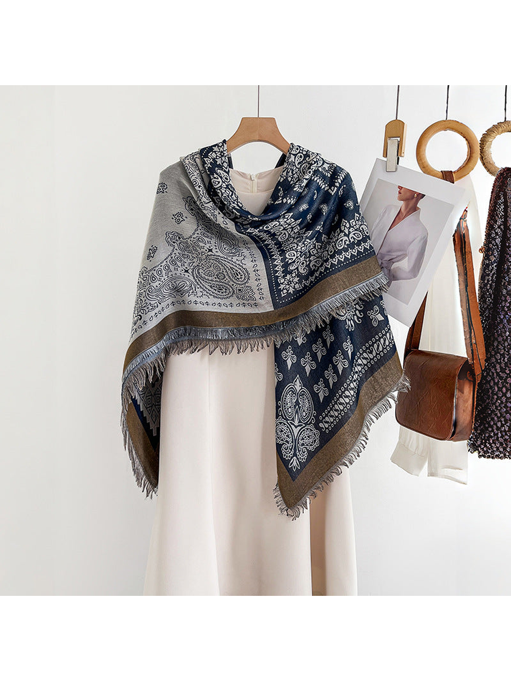 Paisley square scarf draped asymmetrically over a light dress