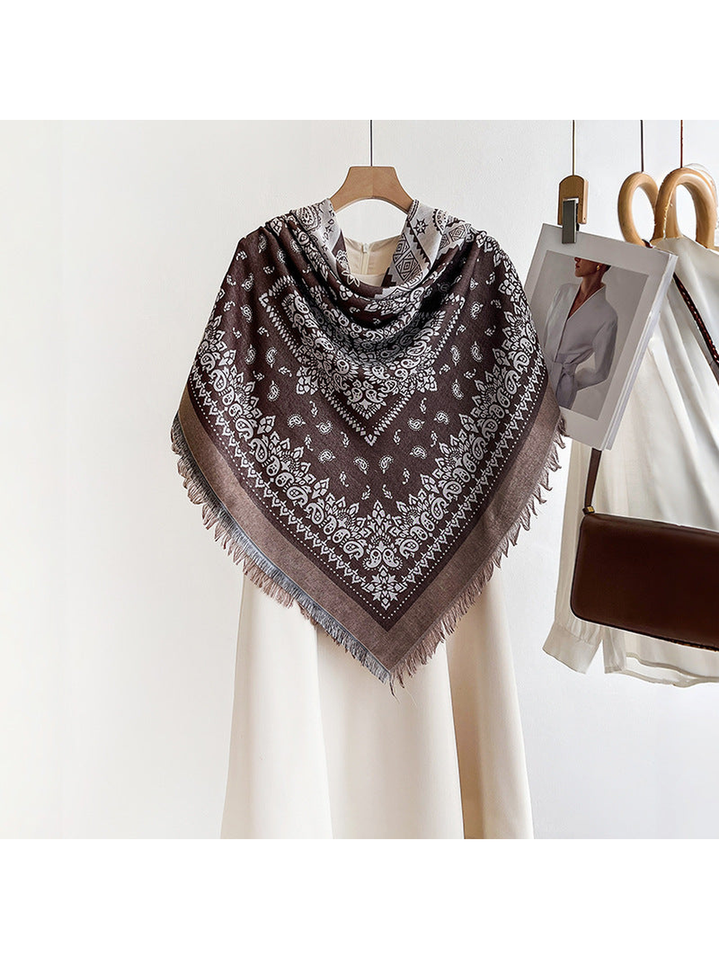 Brown paisley square scarf styled in a triangular shoulder drape