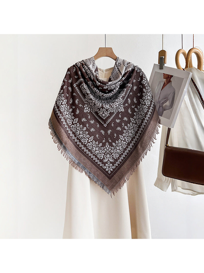 Brown paisley square scarf styled in a triangular shoulder drape
