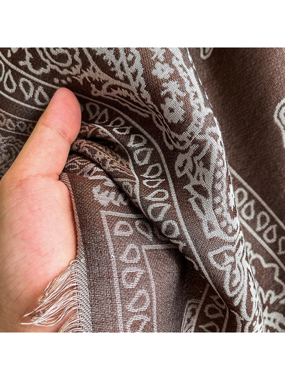 Close-up of the fine woven paisley pattern and short fringed edge