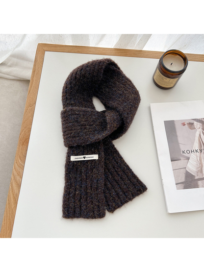 Dark brown fuzzy ribbed scarf arranged in a loop