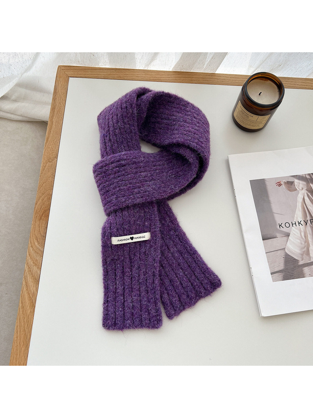Purple fuzzy ribbed scarf arranged in a loop