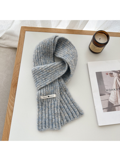 Gray-blue fuzzy ribbed scarf arranged in a loop