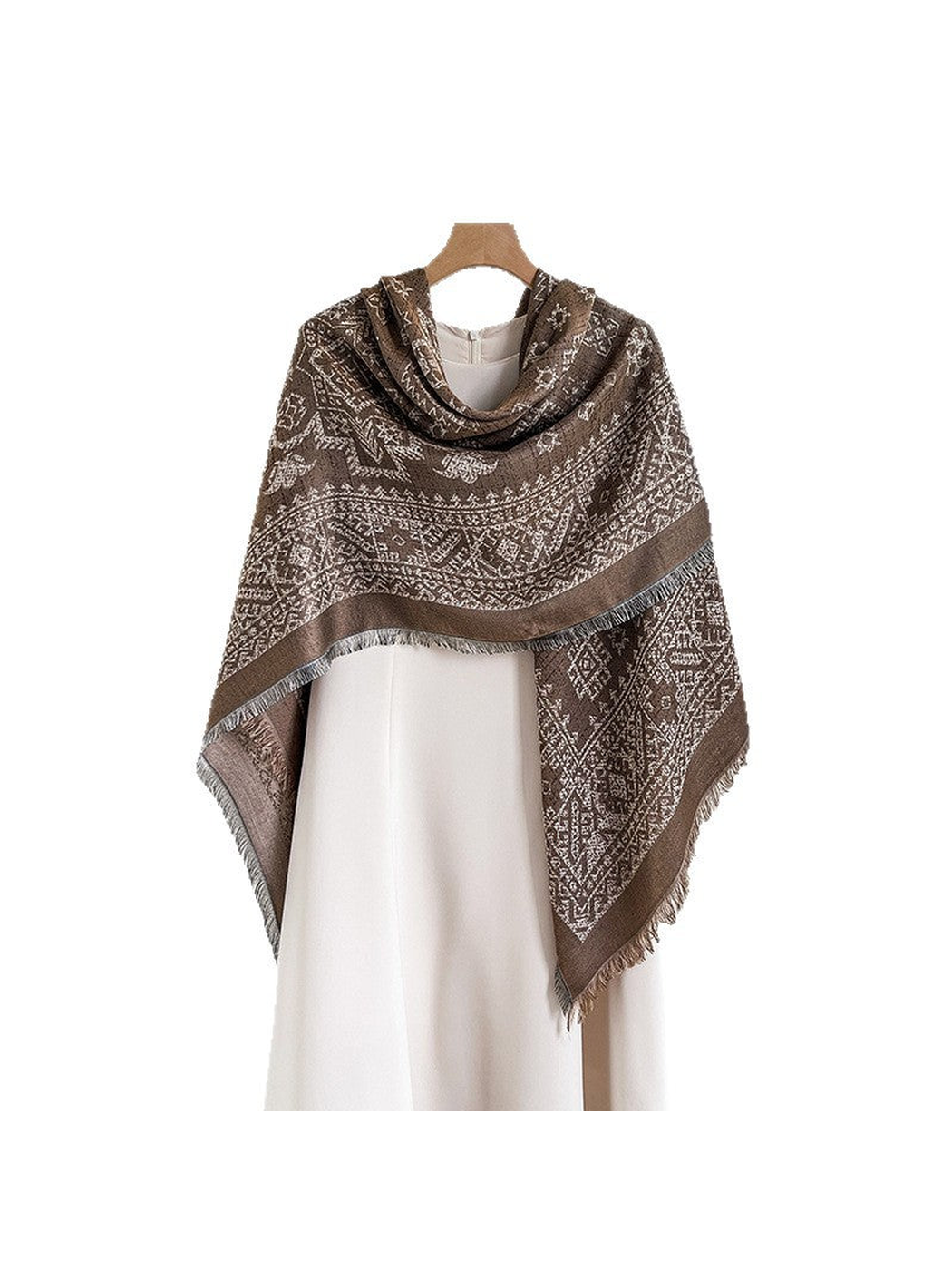 Brown geometric square scarf draped asymmetrically over a cream dress