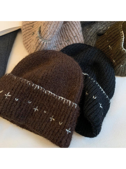 Assorted fuzzy ribbed beanies with contrasting stitched motifs