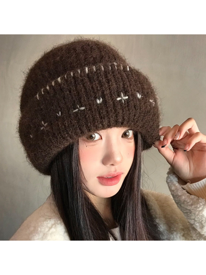 Brown fuzzy ribbed beanie with a wide folded cuff, angled worn view