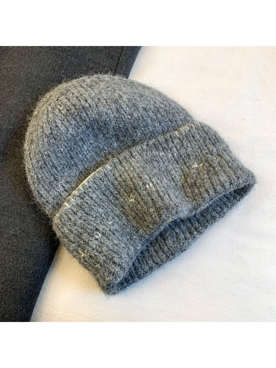 Gray fuzzy ribbed beanie with contrasting stitched motifs