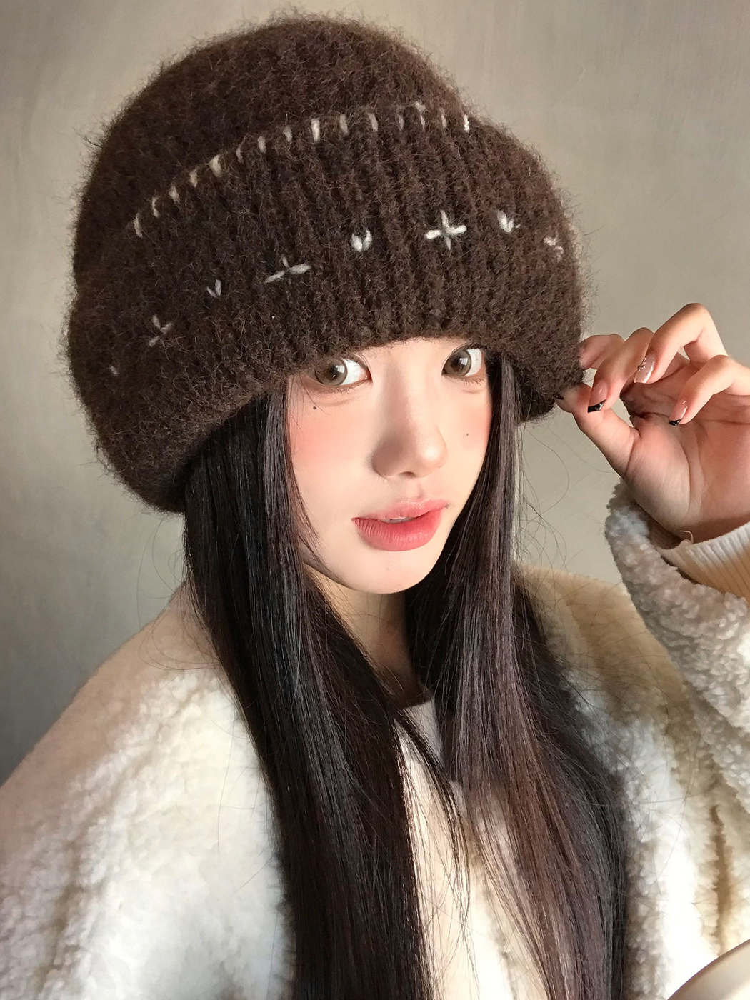 Brown fuzzy ribbed beanie showing the folded cuff and whipstitch edge