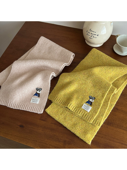 Cream and mustard yellow scarves laid flat to show their fuzzy texture and ribbed ends