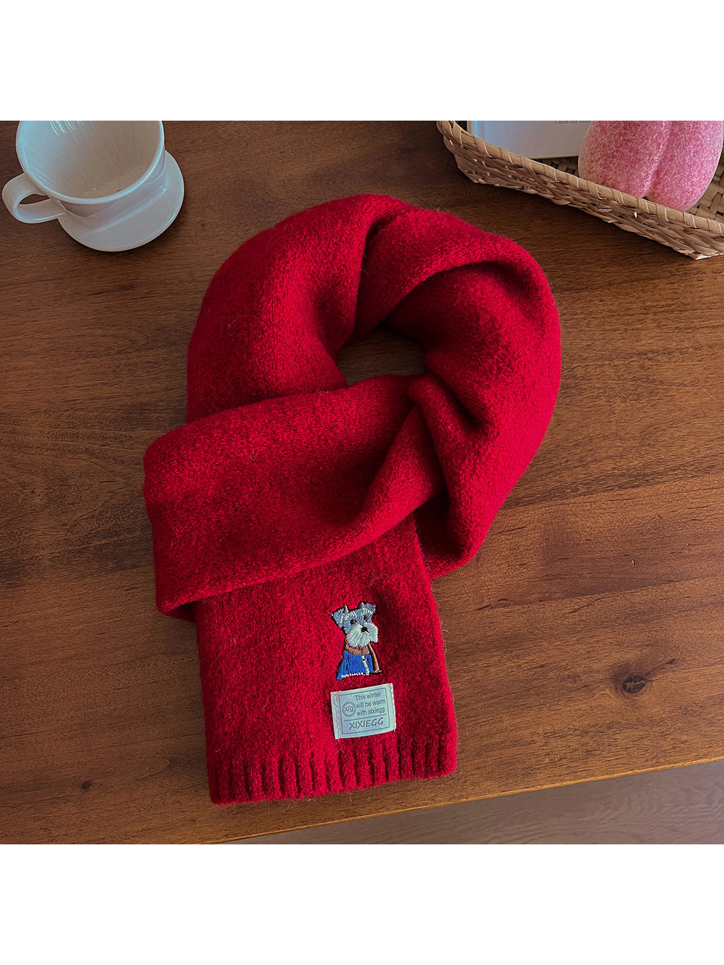 Red fuzzy scarf with embroidered dog motif and ribbed end